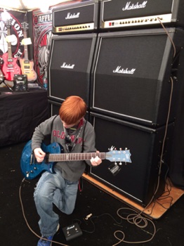 Student playing guitar at The Crazy Dave's Music Experience